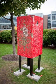 Red rectangular shape on metal legs.